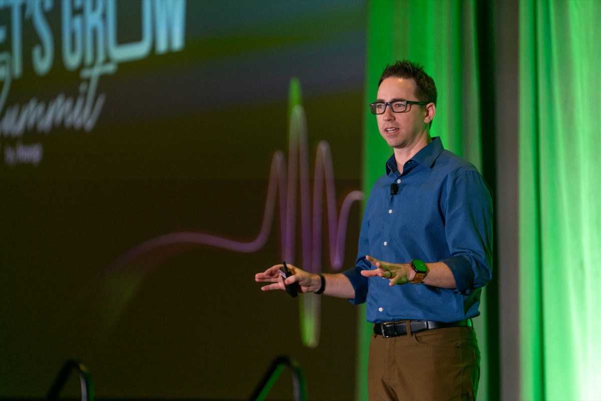 Ammon Curtis speaking on stage